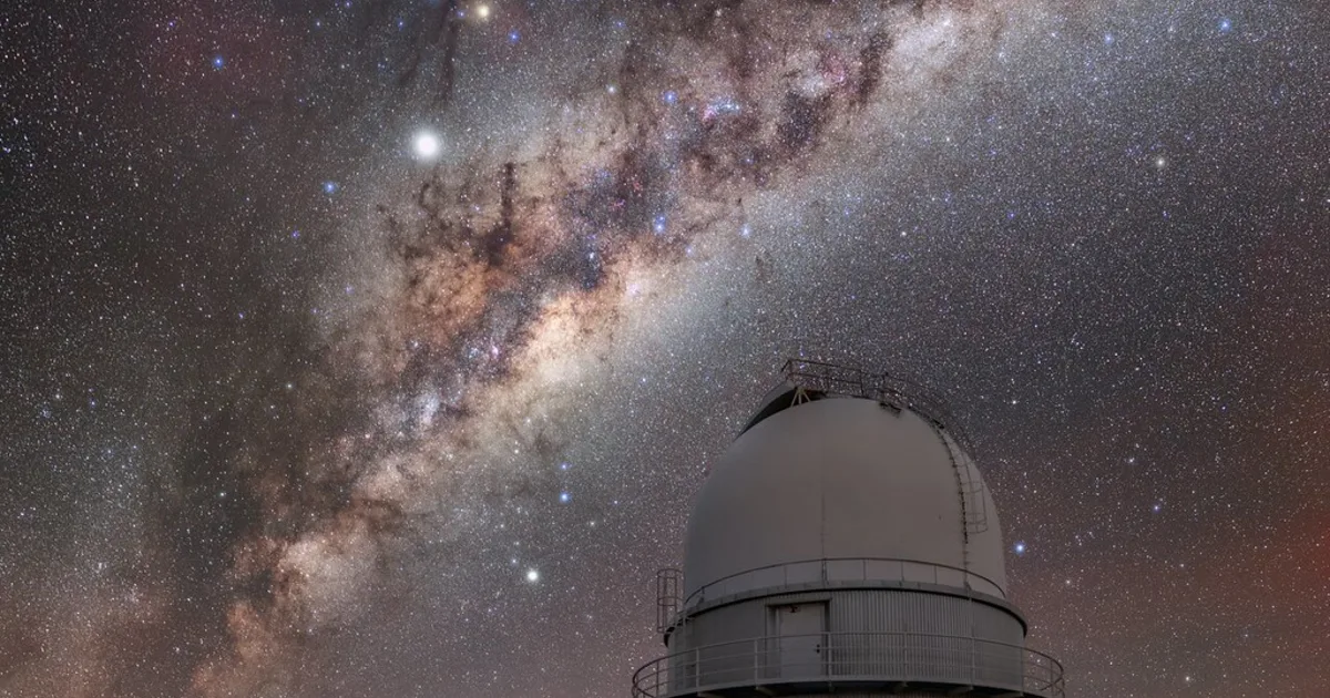 A telescope observatory silhouetted against a starry night sky